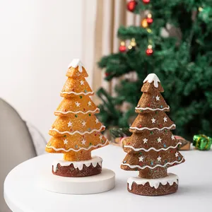 Detail of gingerbread Christmas tree resin ornaments with sugar texture and festive icing