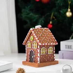 Close-up of a resin gingerbread house ornament with candy textures and festive decor