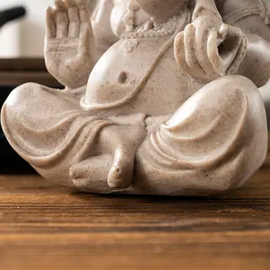 Detailed close-up of textured resin Ganesha statue showing seated pose and granite finish