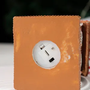 Detail view of the Christmas gingerbread house resin base with battery compartment and switch