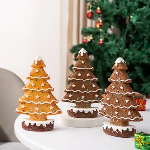 Detailed view of gingerbread style Christmas tree tabletop ornaments with snow-like texture