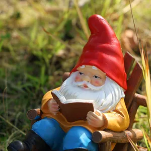 Detailed close-up of a resin garden gnome reading a book in a wooden rocking chair