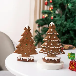 Close-up of resin gingerbread Christmas tree ornaments on a festive tabletop display