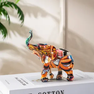 Detailed view of artistic resin elephant statue with vibrant colorful graffiti patterns