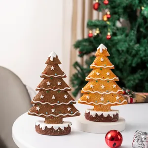 Detail of gingerbread Christmas tree ornaments with icing accents and star toppers