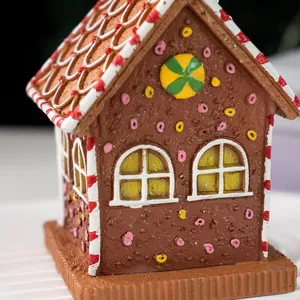 Macro detail of gingerbread house decor with red candy swirl roof and resin textures