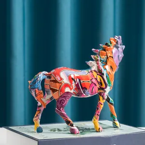 Graffiti art horse statue made of resin, colorful desktop decor on a blue book
