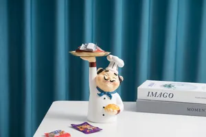 Détail d'une statuette de chef avec un plateau doré pour le rangement de l'entrée