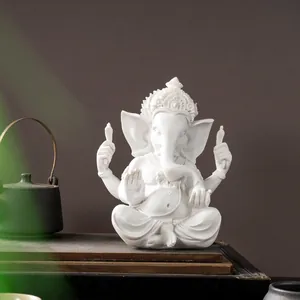 Detailed view of a white Ganesha resin statue in a serene Zen-inspired setting