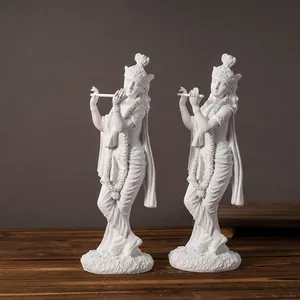 Two white Krishna resin statues in flute playing pose on wooden base for home decor