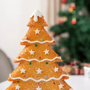 Macro shot of gingerbread-style Christmas tree resin ornament with foam texture and stars
