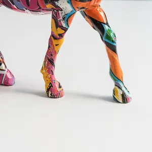Detailed close-up of colorful graffiti patterns on resin horse sculpture legs