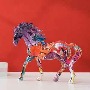 Detailed close-up of a resin horse statue with vibrant street art graffiti on a red backdrop