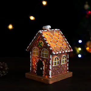 Glow-in-the-dark resin gingerbread house with faux icing and snowy chimney decor