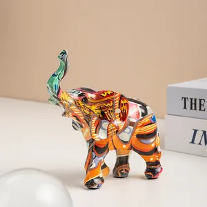 Close-up of modern resin elephant statue with vibrant colorful graffiti art pattern