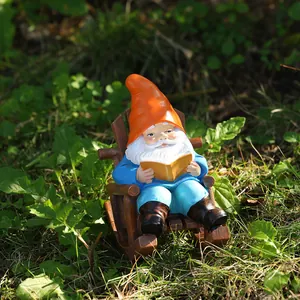 Detailed close-up of a garden gnome reading on a rocking chair in a natural grass setting
