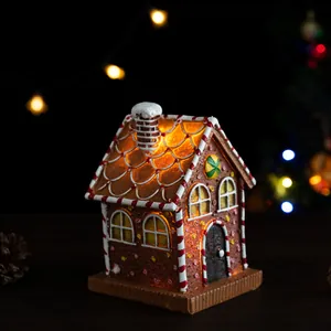 Macro detail of gingerbread house night light with warm LED glow and candy decorations