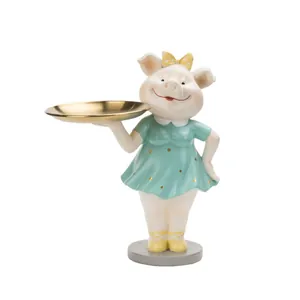 Figurine de cochon rose tenant un plateau doré pour le rangement d'entrée de maison