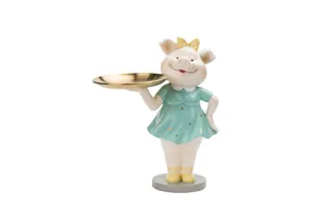 Détail d'une figurine de cochon en résine avec plateau doré pour clés et bijoux