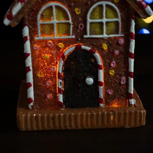 Macro view of gingerbread house night light with warm LED glow and festive candy details