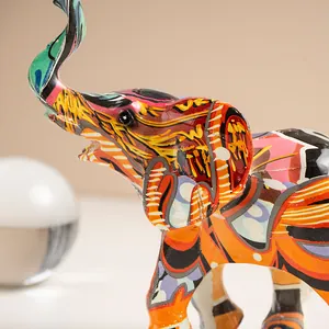 Close-up of a colorful graffiti elephant resin ornament with artistic side detail
