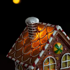 Macro view of gingerbread house ornament with warm LED lighting and frosting details