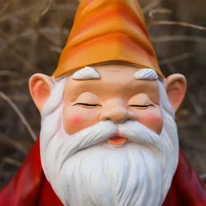 Close-up of a meditating garden gnome statue with an orange hat and white beard