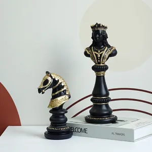 Modern black and gold resin chess ornaments featuring a Knight and Queen on a desk