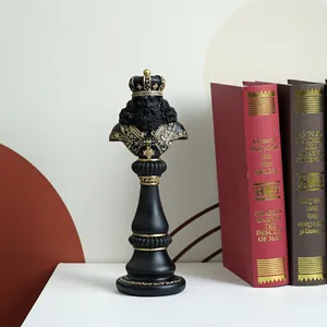 Detailed macro of a black resin chess king statue with gold vintage royal carvings