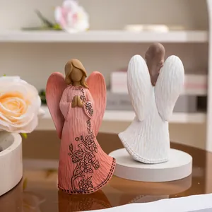 Detailed view of hand-carved wood texture and floral patterns on resin angel statues