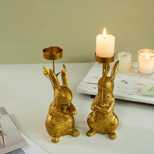 Set of two golden rabbit candle holders with intricate leaf texture for home decor