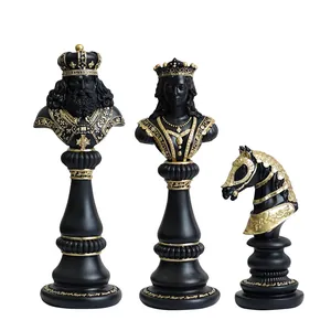 Three-piece black and gold resin chess set featuring King, Queen, and Knight statues