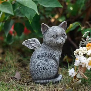 Détail de la statue commémorative chat ange avec gravure Forever Loved sur l'herbe du jardin
