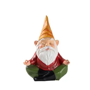 Macro shot of a meditating garden gnome statue with orange hat and yoga pose