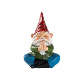 Detailed close-up of a meditating garden gnome statue with white beard and red hat