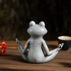 Rear view of a meditating frog statue with stone texture on a cozy wooden table