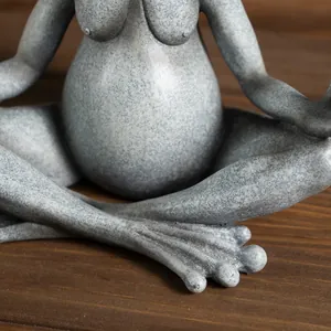 Macro detail of anthropomorphic yoga frog statue with realistic stone texture and finish