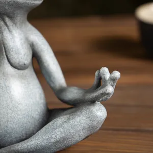 Macro shot of Zen yoga frog statue featuring detailed grey-blue matte ceramic texture