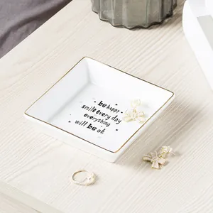 Square ceramic jewelry tray with gold trim and motivational quote for jewelry storage