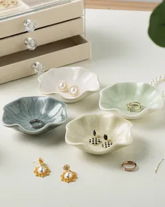 Detail of petal-shaped ceramic jewelry trays in pastel tones for ring storage