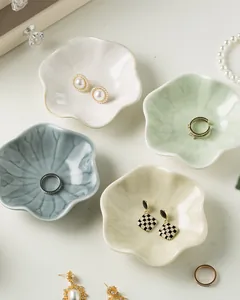Macro detail of petal-shaped ceramic jewelry trays in assorted soft pastel colors
