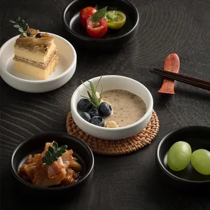 Minimalist round ceramic dipping sauce bowls in matte black and white finishes