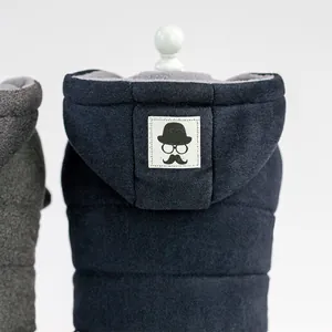 Quilted blue pet winter vest with warm fleece lining and mustache graphic on hood