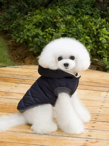 Detail of navy quilted pet vest with ribbed trim on a white poodle in outdoor setting