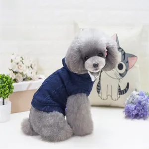 Detail of dark blue cable knit pet sweater with hood on a gray poodle dog