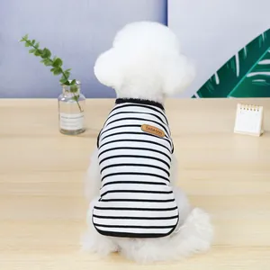Close-up of a striped pet T-shirt with black and white patterns and leather tag detail