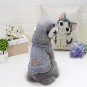 Detail of grey cable knit dog sweater featuring a leather brand patch on the back