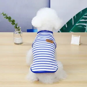 Blue and white striped dog vest with premium leather tag detail on soft cotton fabric