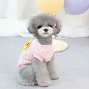 Detailed knit texture and sunflower patch on a pink dog sweater for small pets