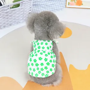 Detail of floral pet dress with green daisy pattern on light breathable cotton fabric